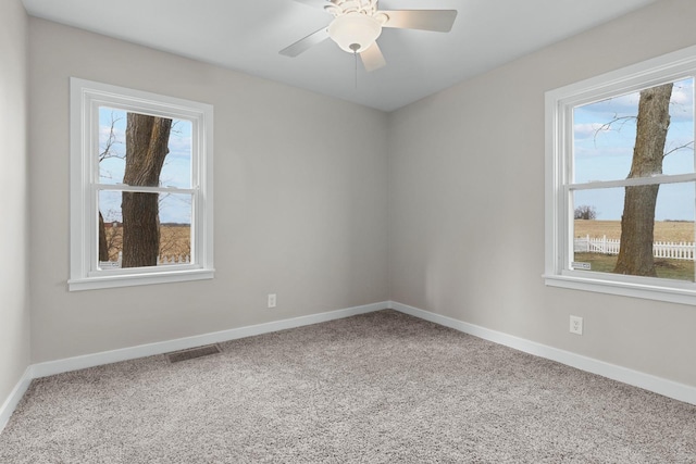 spare room featuring carpet and ceiling fan