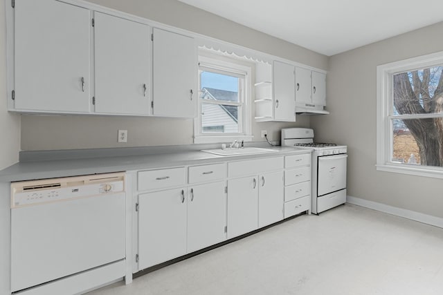 kitchen featuring white cabinetry, sink, and white appliances