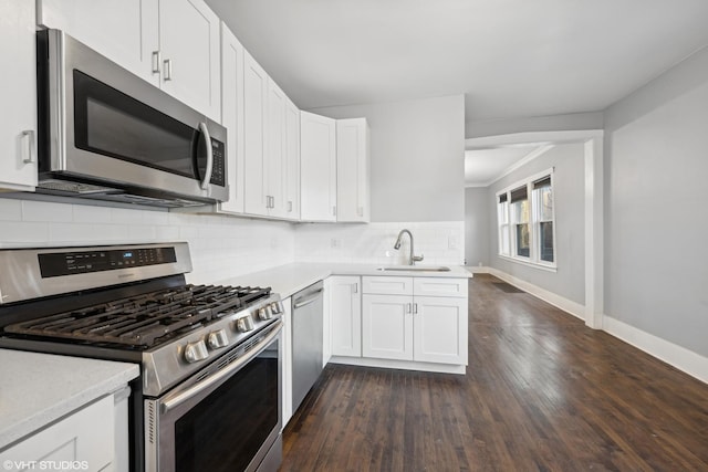 kitchen with white cabinets, stainless steel appliances, dark wood-type flooring, and sink