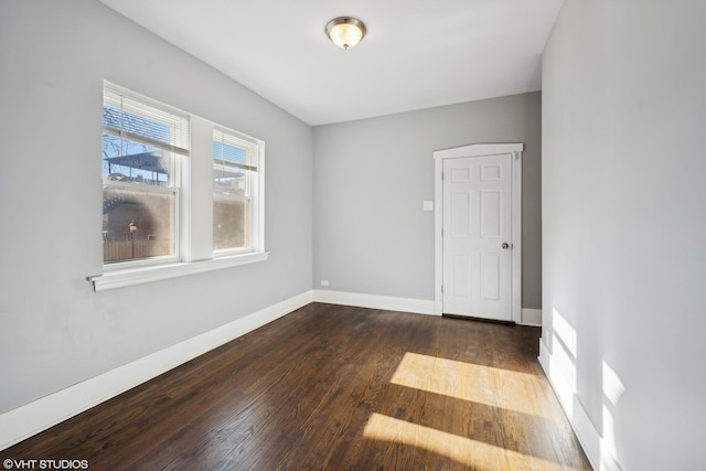 spare room with dark hardwood / wood-style floors