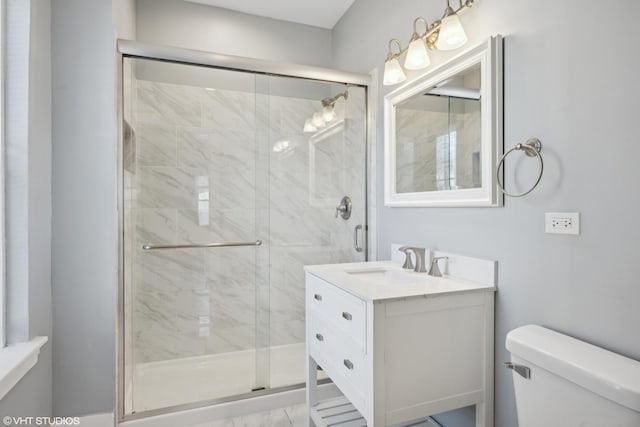 bathroom with vanity, toilet, and walk in shower