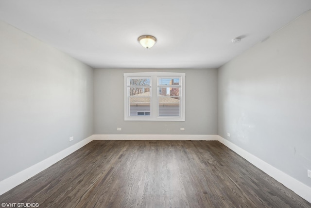 spare room featuring dark hardwood / wood-style floors