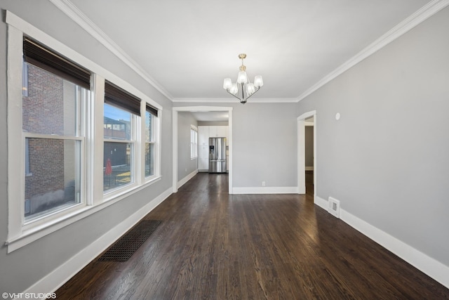 unfurnished room featuring dark wood-type flooring, a chandelier, and ornamental molding