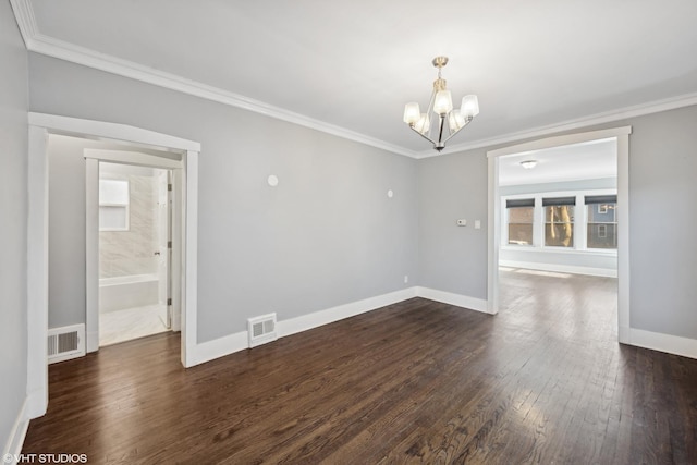 empty room with dark hardwood / wood-style flooring, crown molding, and a chandelier