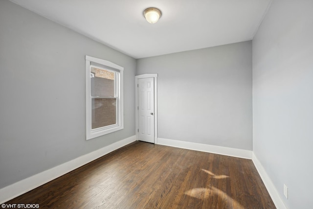 spare room featuring dark hardwood / wood-style floors