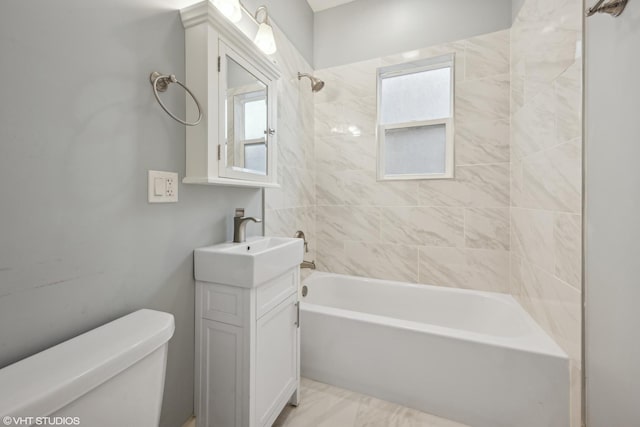 full bathroom with vanity, toilet, and tiled shower / bath