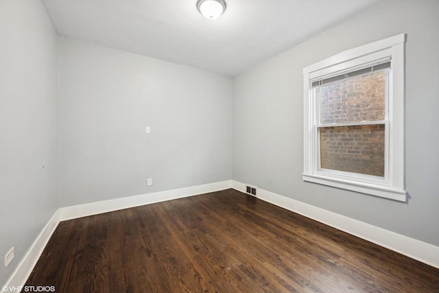 empty room with hardwood / wood-style flooring