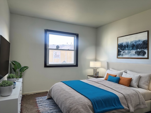 bedroom with dark colored carpet