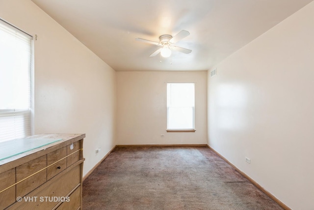 carpeted empty room featuring ceiling fan