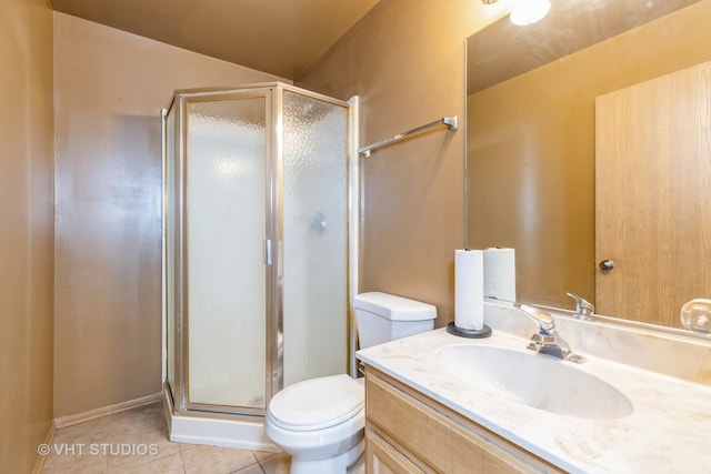 bathroom featuring toilet, tile patterned flooring, vanity, and walk in shower