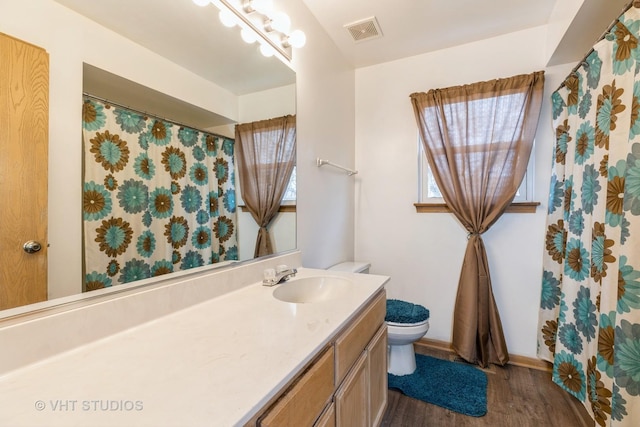 bathroom with hardwood / wood-style flooring, vanity, and toilet