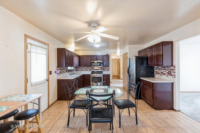 kitchen with appliances with stainless steel finishes, backsplash, ceiling fan, and sink