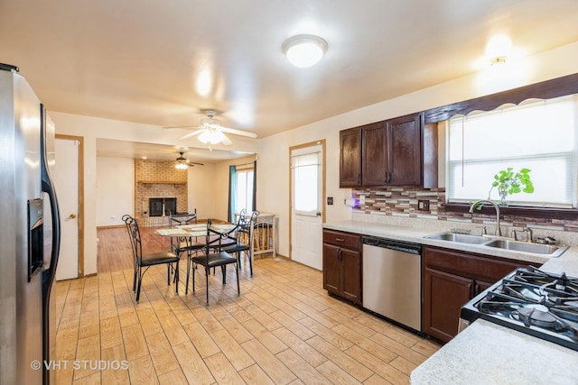 kitchen with sink, ceiling fan, appliances with stainless steel finishes, tasteful backsplash, and plenty of natural light