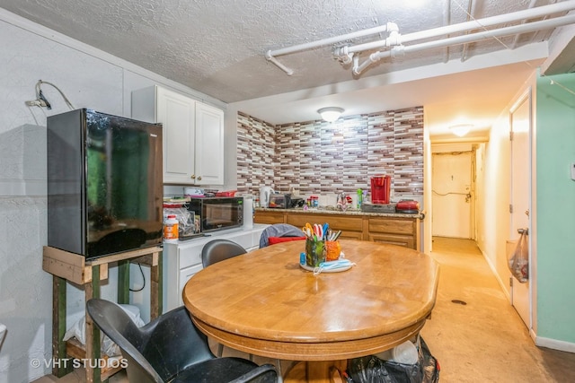 dining area featuring a textured ceiling