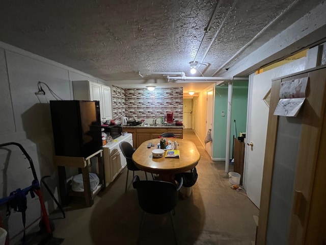 dining space featuring a textured ceiling