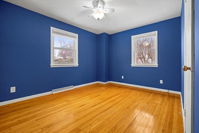 empty room featuring ceiling fan and light wood-type flooring