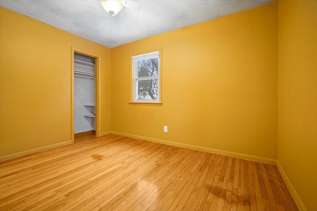 unfurnished bedroom with light wood-type flooring and a closet