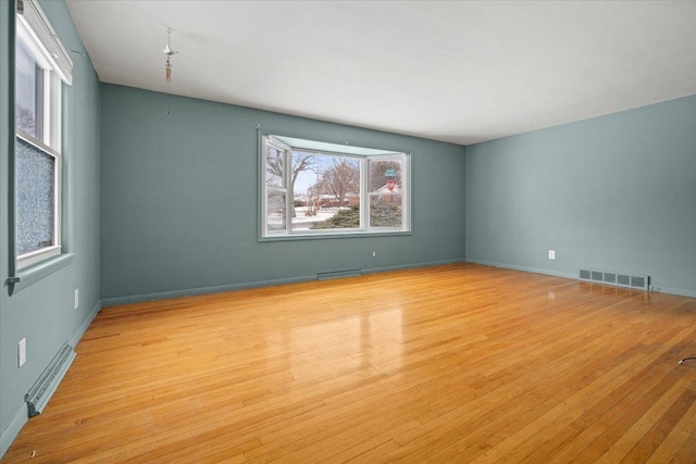 empty room featuring plenty of natural light and light wood-type flooring