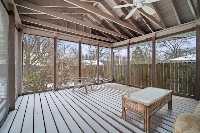 unfurnished sunroom with vaulted ceiling and ceiling fan