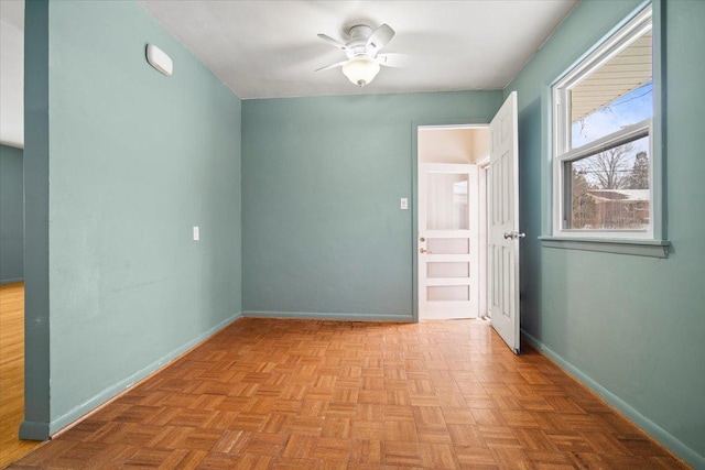 spare room featuring light parquet floors and ceiling fan