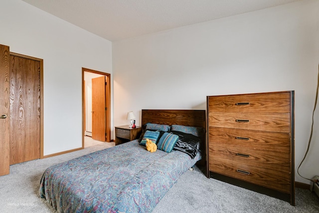 carpeted bedroom with a baseboard radiator