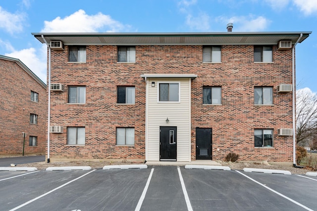 view of building exterior featuring a wall unit AC