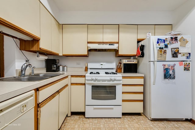 kitchen with cream cabinets, white appliances, and sink