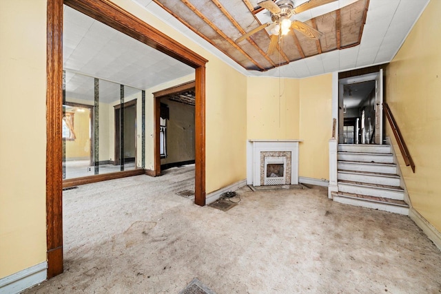 unfurnished living room with ceiling fan