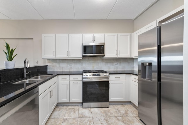 kitchen with appliances with stainless steel finishes, sink, and white cabinets