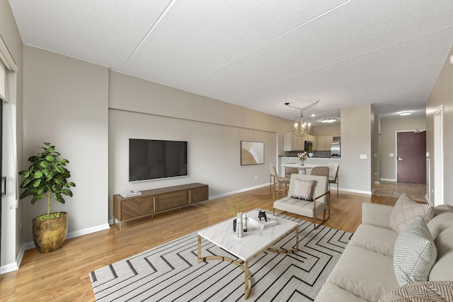 living room with a chandelier and light hardwood / wood-style floors