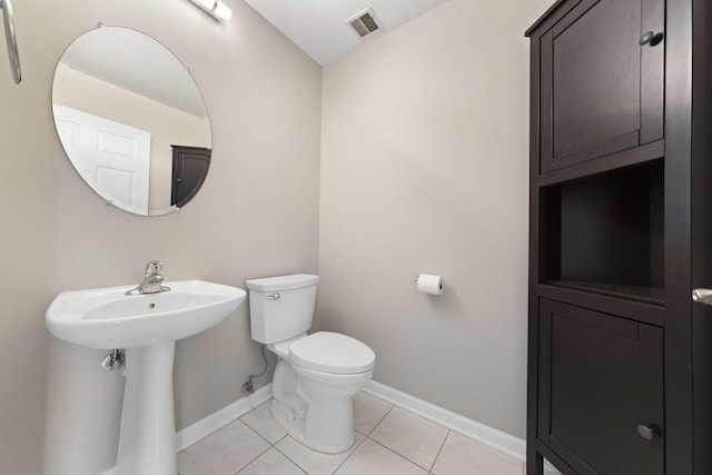 bathroom featuring sink, toilet, and tile patterned flooring