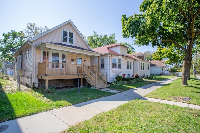 view of front of home featuring covered porch and a front lawn