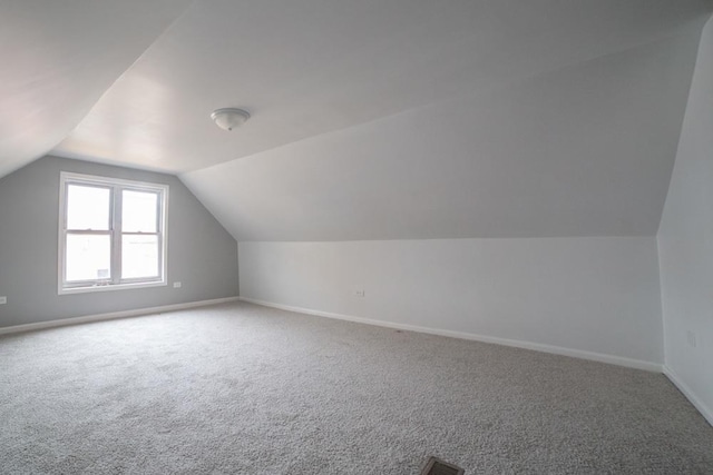 bonus room featuring carpet floors and lofted ceiling