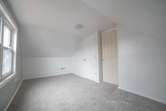 bonus room with a wealth of natural light, carpet floors, and lofted ceiling