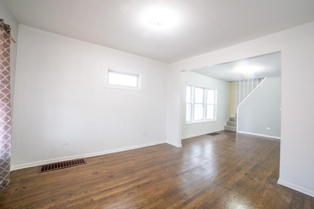 unfurnished room with dark hardwood / wood-style flooring