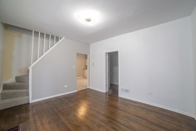 empty room featuring dark wood-type flooring