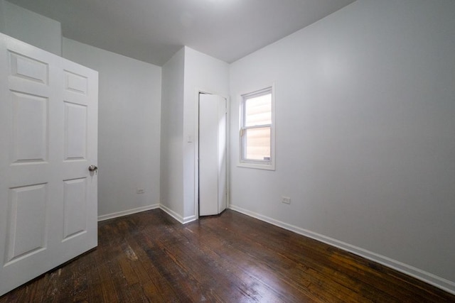 unfurnished bedroom featuring dark hardwood / wood-style flooring