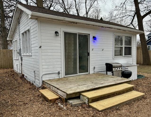 back of property featuring a wooden deck