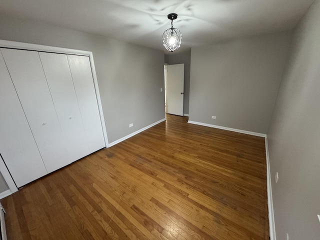 unfurnished bedroom with a closet and wood-type flooring