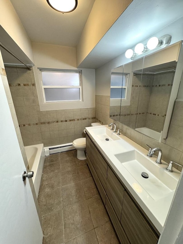 bathroom with vanity, tile patterned floors, toilet, baseboard heating, and tile walls