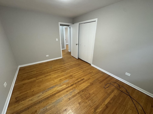 unfurnished bedroom with light hardwood / wood-style floors and a closet