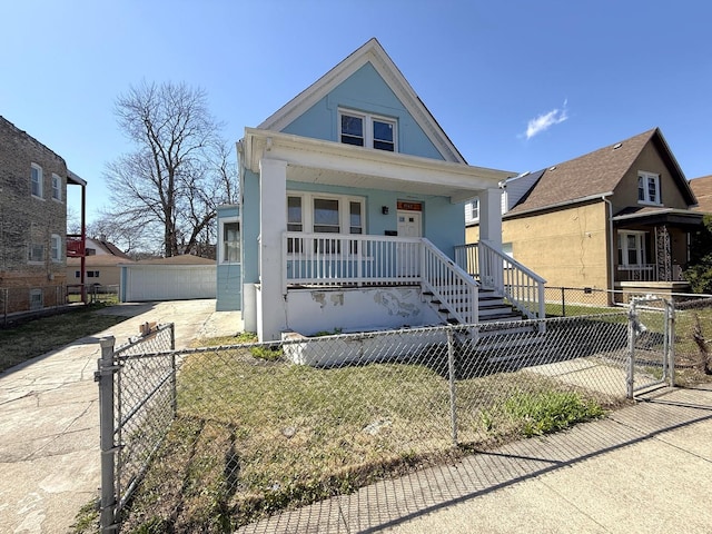 view of front of home with an outbuilding, a porch, a gate, and a fenced front yard
