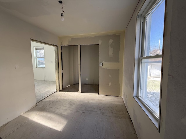 unfurnished bedroom with multiple windows