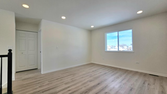 empty room with light hardwood / wood-style floors