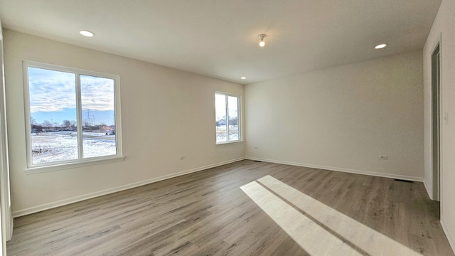 empty room with light hardwood / wood-style floors