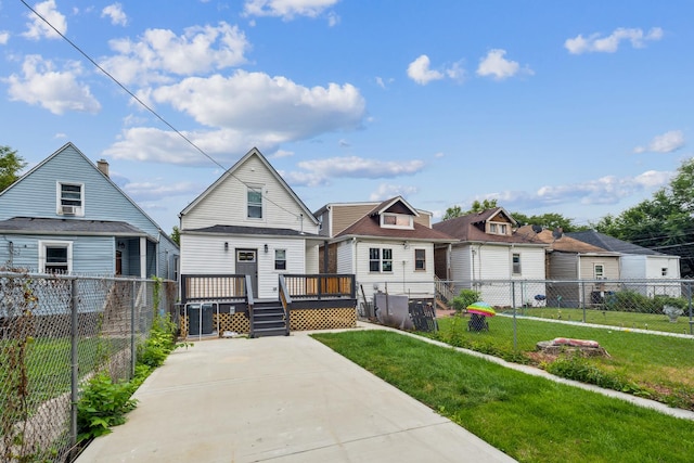 view of front of property featuring a wooden deck and a front lawn