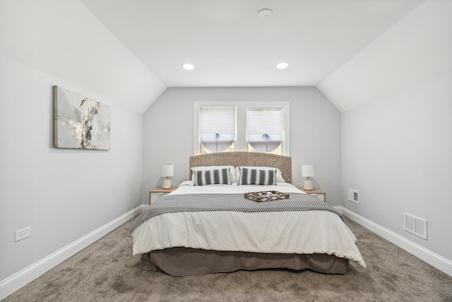 carpeted bedroom featuring lofted ceiling