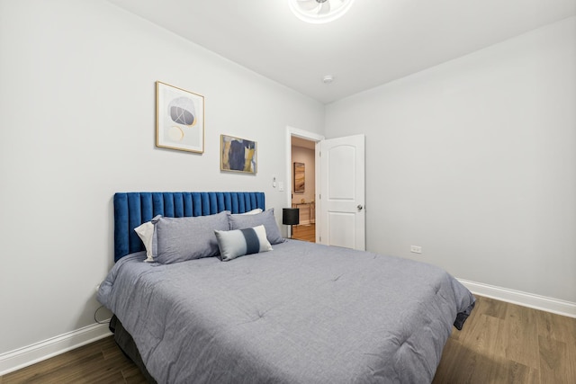 bedroom with dark hardwood / wood-style flooring