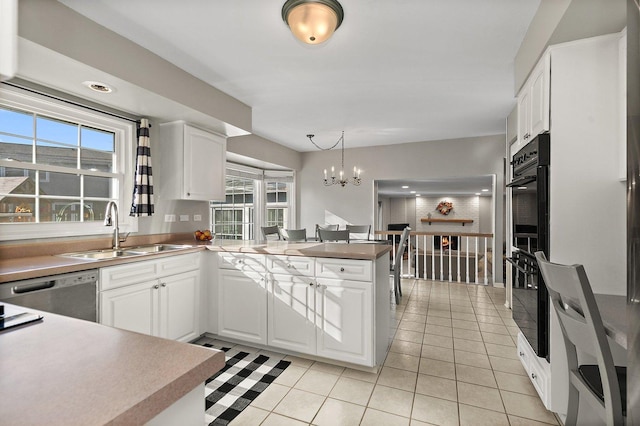 kitchen featuring white cabinets, hanging light fixtures, and sink