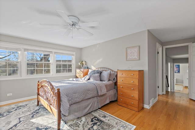 bedroom with light wood-type flooring and ceiling fan